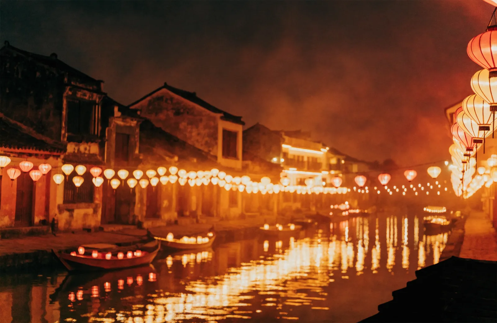 Lantern-lit Hoi An Ancient Town at night, warm reflections on the river